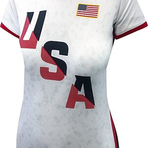 May include: White short-sleeved shirt with a red, white, and blue USA graphic and a small American flag on the chest.