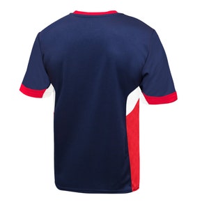 May include: A navy blue short-sleeved jersey with white and red accents. The jersey has a crew neck and a color-blocked design.