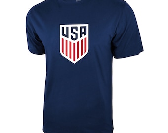 May include: A navy blue t-shirt with a white and red USA crest on the front.