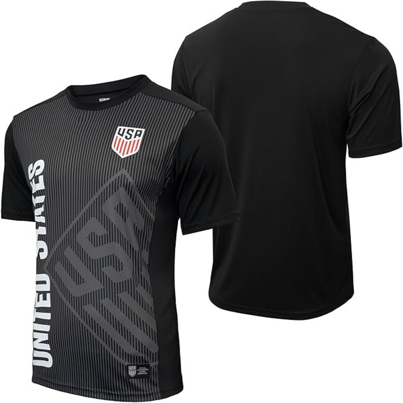 May include: Black soccer jersey with a gray and white graphic design featuring the words "United States" and "USA".