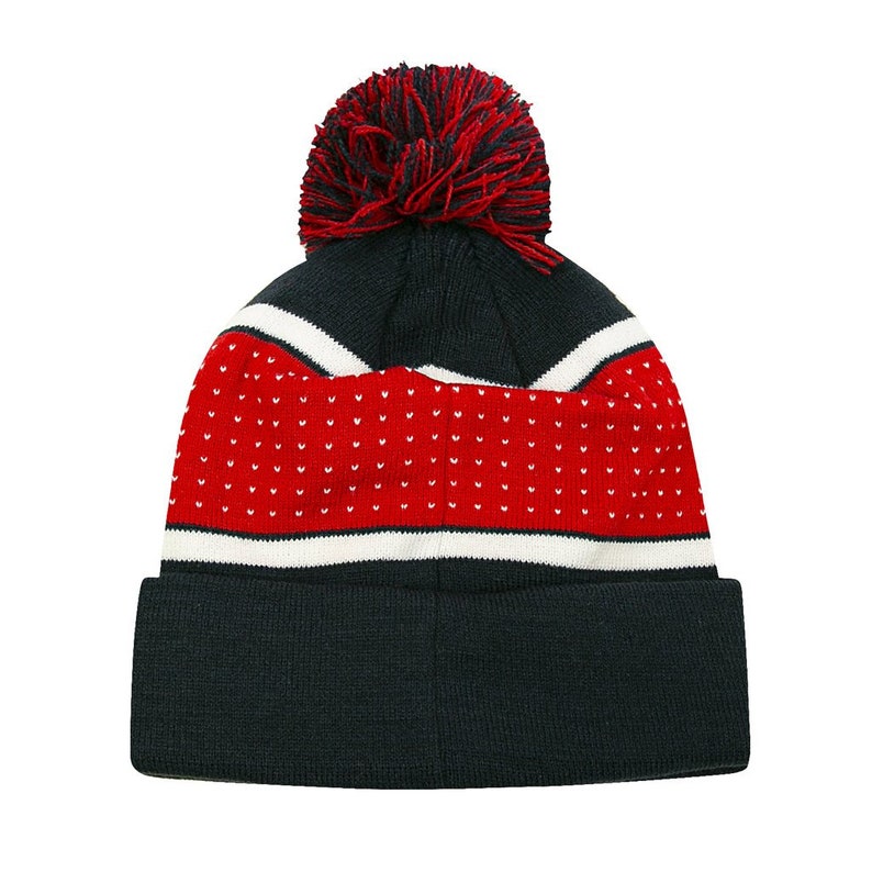 May include: A navy blue knit beanie with a red and white stripe pattern and a red pom pom on top.