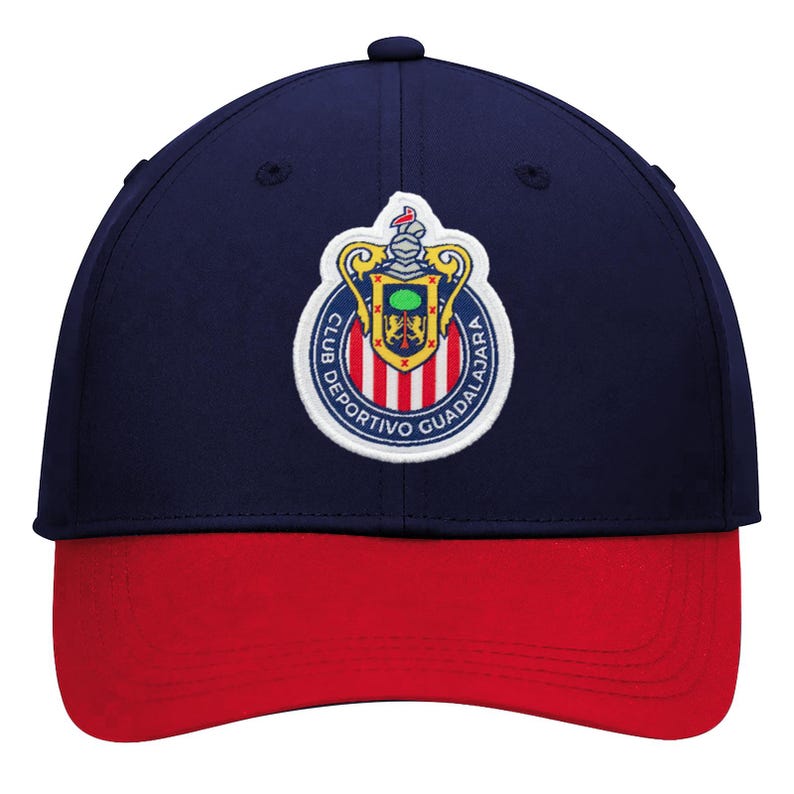 May include: A navy blue baseball cap with a red brim. The cap features an embroidered emblem with a shield, stripes, and the words "Club Deportivo Guadalajara" in white lettering. The cap has a curved bill and a button on top.