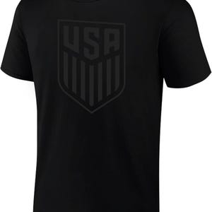 May include: Black t-shirt with a large, gray, USA shield graphic on the front.