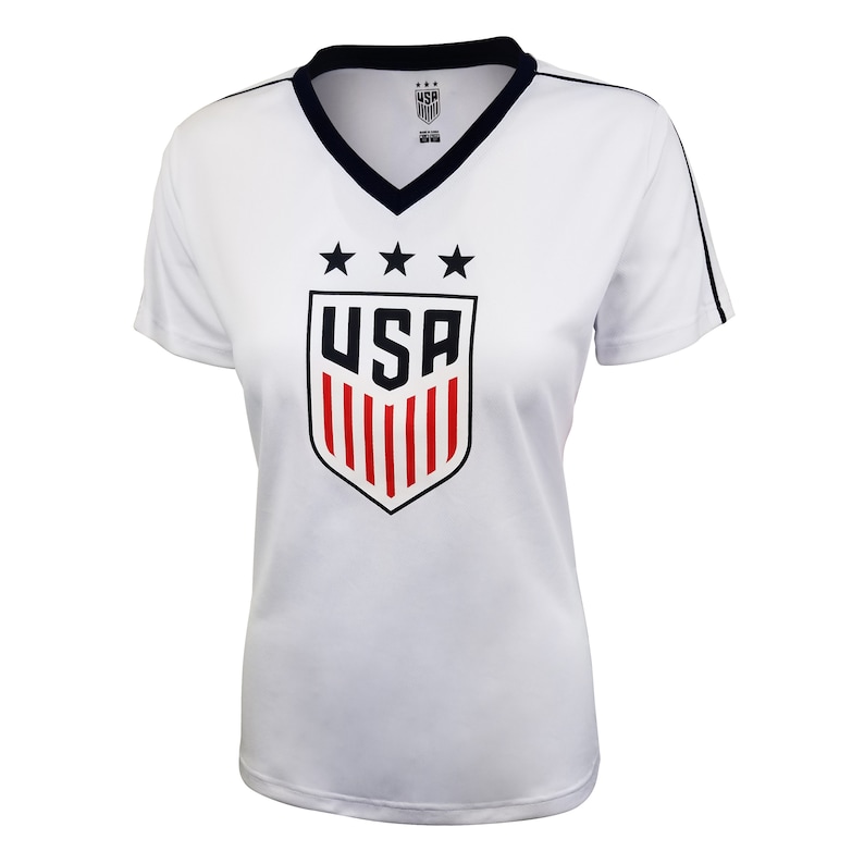 May include: White short-sleeved t-shirt with a navy blue v-neck collar and navy blue trim on the sleeves. The shirt features a red, white, and blue USA crest with three stars above the crest.