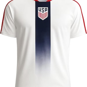 May include: White athletic jersey with a navy blue vertical stripe down the center and red accents. The jersey features the USA logo on the chest and red stripes along the shoulders. The shirt has a crew neck and short sleeves.