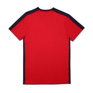 May include: A red short-sleeved t-shirt with navy blue trim on the sleeves and sides.