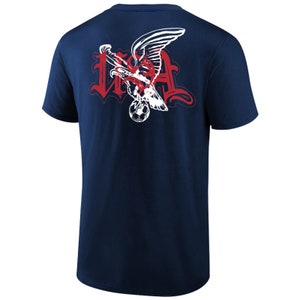 May include: Navy blue t-shirt with a white graphic of an eagle holding a soccer ball with the word "USA" in red lettering.