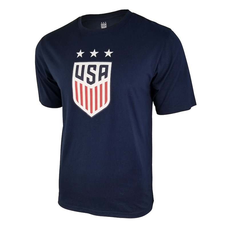May include: A navy blue t-shirt with a white and red USA crest featuring three stars and the word "USA" in white.