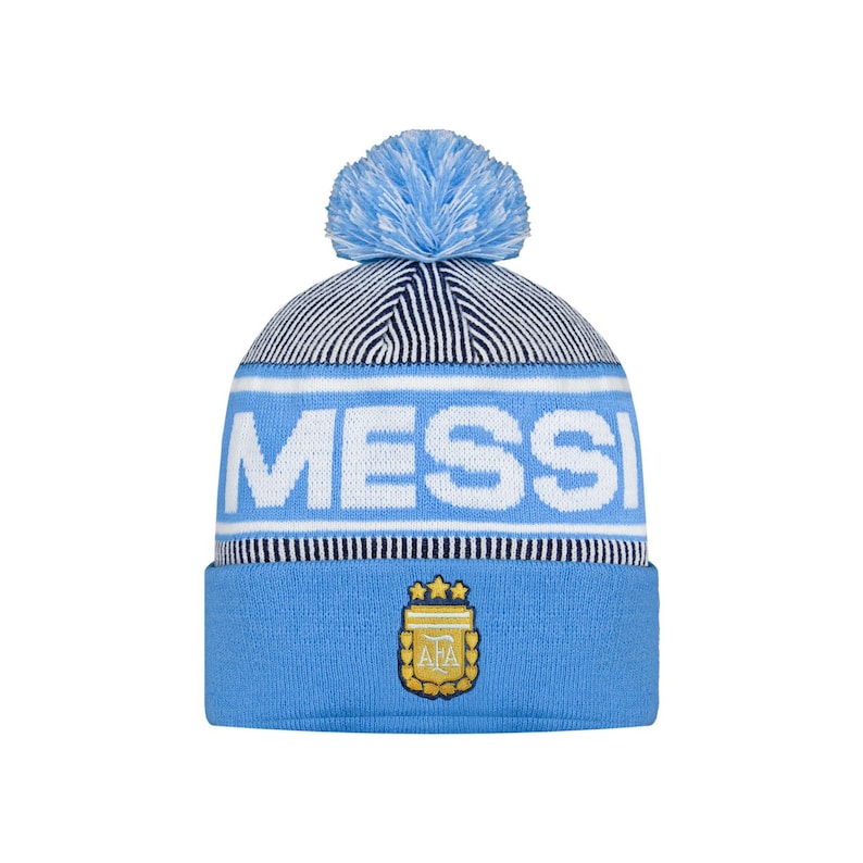 May include: A light blue knitted beanie hat with a matching pom-pom. The word "MESS" is displayed in white block letters across the front. Below the text is a light blue band with the Argentina Football Association logo.