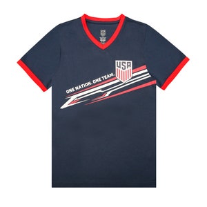 May include: A navy blue t-shirt with red trim and a white graphic design. The graphic features a red, white, and blue USA logo with the text "One Nation. One Team."