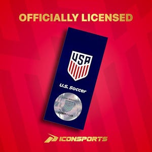 May include: A rectangular dark blue tag featuring the white and red U.S. Soccer crest, the text U.S. Soccer, and a circular silver holographic sticker with the U.S. Soccer logo and code DZ8951 LJS. The text OFFICIALLY LICENSED and ICONSPORTS appear in gold.