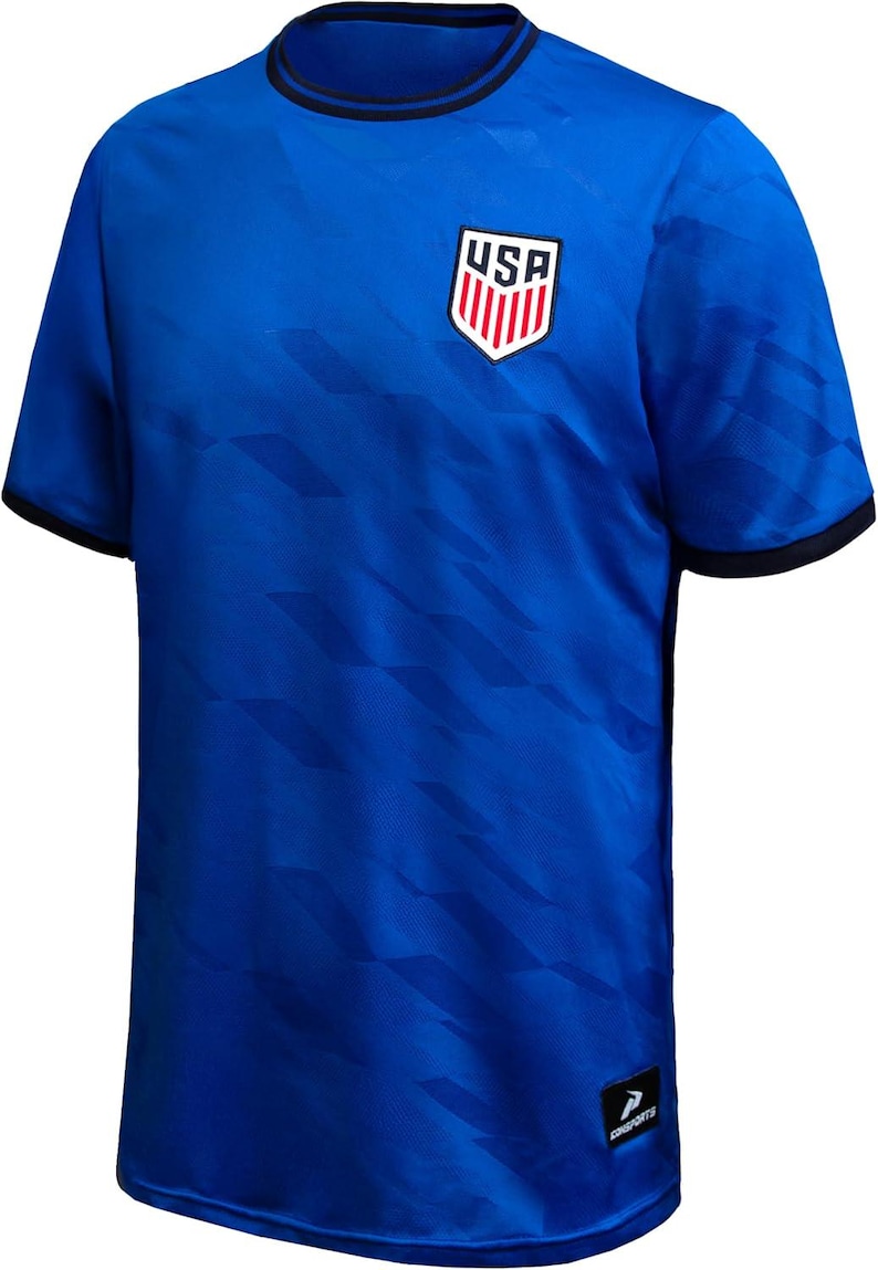 May include: Royal blue soccer jersey with a geometric pattern and black trim. The jersey features the USA emblem on the chest. The shirt is short-sleeved and has a crew neck.