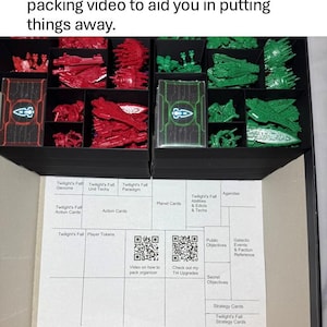 May include: Black deck box organizer with red and green game pieces. Includes printed aid for organizing deck boxes and a QR code for a packing video. The box is designed for the game Twilight's Fall.