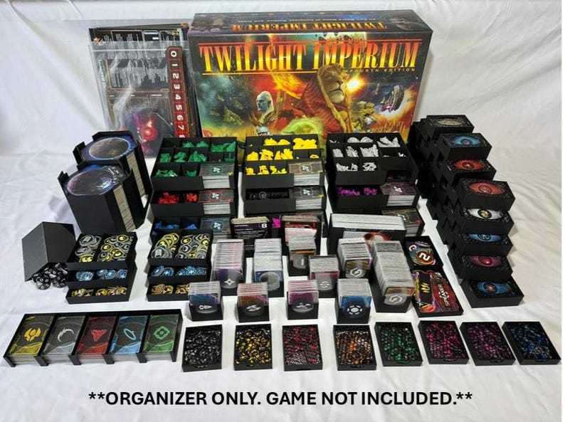 May include: A black game organizer for Twilight Imperium, featuring various compartments for cards, tokens, and game components. The organizer includes multiple trays and boxes, with the game box visible in the background. The text "ORGANIZER ONLY. GAME NOT INCLUDED." is at the bottom.
