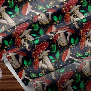 May include: A seamless pattern featuring red and white mushrooms with white spots on a dark blue background. The mushrooms are surrounded by green leaves and gold glitter.