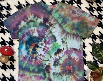 May include: A tie-dye t-shirt with a swirling pattern of blue, green, purple, and brown colors.