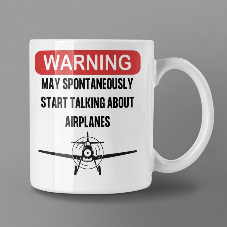 May include: White ceramic mug with a red warning sign that says "WARNING MAY SPONTANEOUSLY START TALKING ABOUT AIRPLANES". A black silhouette of a small airplane is below the text.