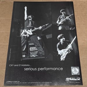 May include: Black and white photo of three musicians playing electric guitars on stage. The photo is for a CKY and D'Addario advertisement. The text "CKY and D'Addario... serious performance" is at the bottom of the photo.