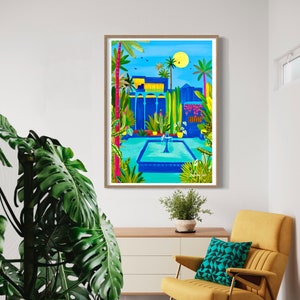 May include: A framed illustration of a blue building with a fountain in a courtyard. The building has a yellow roof and is surrounded by palm trees and other plants. The sky is blue and there is a yellow sun in the upper right corner.