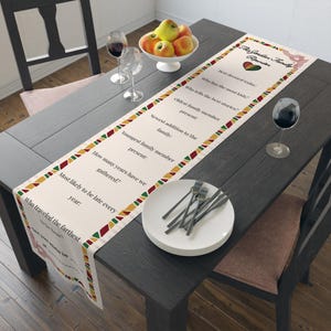 May include: A cream-colored table runner featuring a red, yellow, and green geometric border. The text reads The Jordan Family Reunion, followed by a list of questions including Who has the most kids, Oldest family member present, and more.