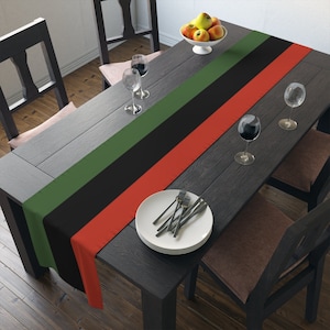 red, green black striped table runner for kwanzaa, or black history month celebration