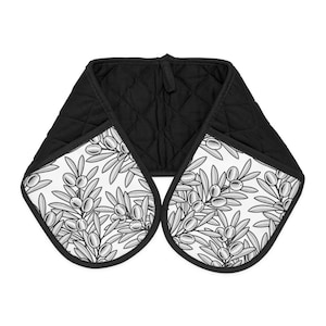May include: Black quilted oven mitts with a white and black olive branch pattern.