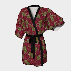 May include: A patterned robe with a floral design in shades of red, green, and gray. The robe has a black trim and a matching belt. The sleeves are wide and the fabric appears soft.