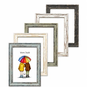 May include: A set of five rectangular picture frames with a distressed finish in black, white, green, beige, and blue. The blue frame contains an illustration of two people under a rainbow umbrella with a dog and the text Warm Inside.