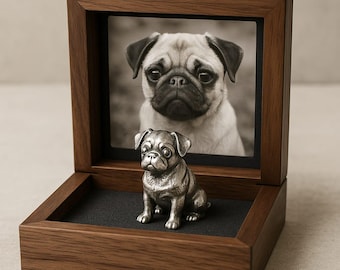 May include: A wooden box with a hinged lid, containing a small silver pug figurine. A photo of a pug is displayed in the lid of the box.