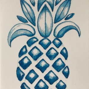 May include: A blue and white watercolor painting of a pineapple with a detailed illustration of the leaves and fruit. The artist's signature, "S. Modert Jan. 18", is in the bottom right corner.