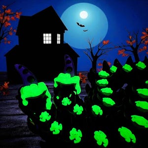 May include: A Halloween-themed image featuring a silhouette of a haunted house, bats, and a full moon. The foreground showcases a black, glowing green, and purple decorative item. The item has a unique, textured design, perfect for spooky decor.