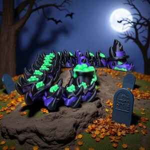 May include: A Halloween-themed display featuring black, purple, and green witch-themed decorations. The decorations include witch hats, cauldrons with bubbling green liquid, and tombstones. The scene is set on a small hill with autumn leaves and a full moon in the background.