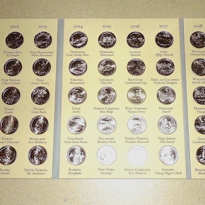 May include: A collection of 50 United States quarter coins, each featuring a different national park. The coins are organized in rows by year of issue, from 2009 to 2013. The coins are displayed in a clear plastic album with a brown background.