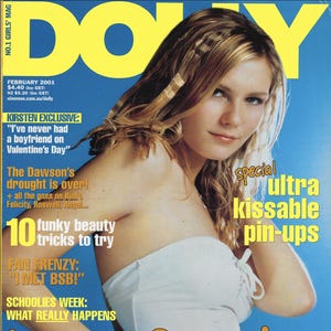 May include: A magazine cover with a blue background and the word "DOLLY" in large yellow letters. The cover features a woman in a white top, with text that reads "love fest!" and "ultra kissable pin-ups."