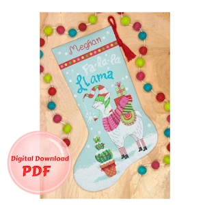 May include: A blue and white Christmas stocking featuring a llama wearing a Santa hat and carrying presents. The stocking is decorated with the text "Fa-la-la Llama" and the name "Meghan".