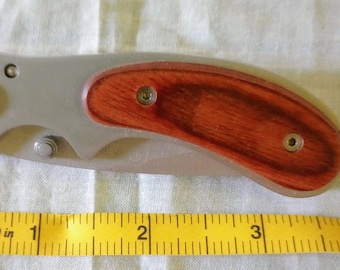 Pocket Knife with wooden handle that folds to close and a belt clip original owner