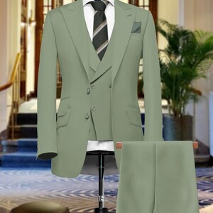 May include: A three-piece suit in a light green color. The suit includes a jacket, vest, and pants. The jacket has a double-breasted closure and a notch lapel. The vest has a single-breasted closure. The pants have a flat front.