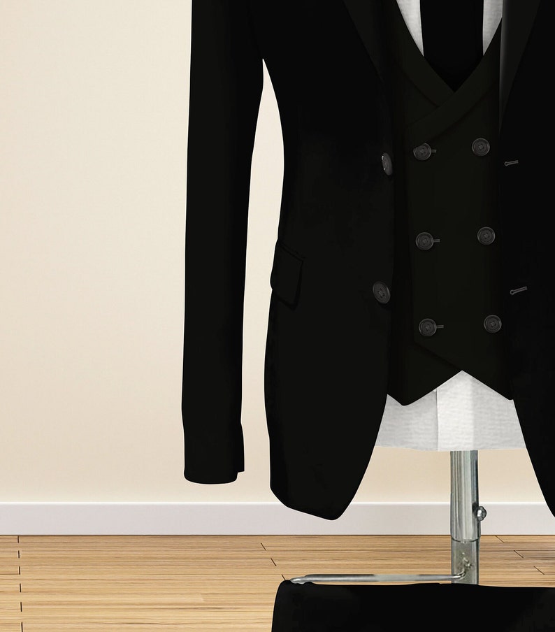 May include: A black suit jacket with a double-breasted closure and a matching vest. The jacket has a long sleeve and a lapel collar.