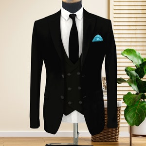 May include: A black three-piece suit with a double-breasted jacket, a vest, and matching pants. The suit is on a mannequin and has a light blue pocket square.