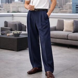 May include: Navy blue pleated trousers with a classic fit. The trousers are paired with a brown leather belt and brown leather dress shoes. The pants have a relaxed, wide leg design, suitable for a variety of occasions.