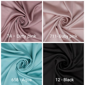 May include: Four swatches of fabric in different colors: dirty pink, baby pink, aqua, and black. Each swatch is labeled with a color name and number. The fabric is folded and swirled, showing its texture and sheen.