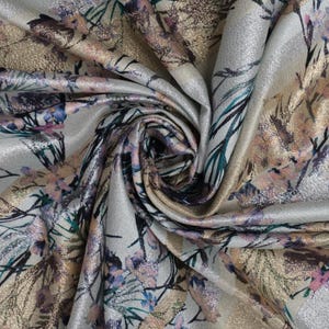 May include: Silver fabric with a floral print in shades of pink, gold, and teal. The fabric has a subtle shimmer.