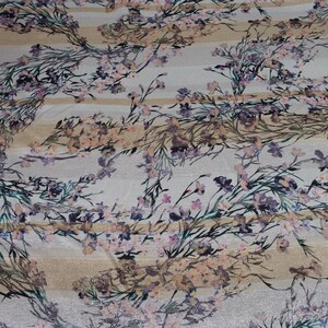 May include: White fabric with a floral print featuring pink, purple, and brown flowers on a background of beige and white stripes.