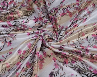 May include: White satin fabric with a pink and gold floral print. The fabric has a subtle sheen and a soft, luxurious feel.