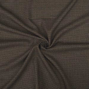 May include: Close-up of a brown and black houndstooth fabric. The fabric is tightly woven with a repeating pattern of small, square checks. The fabric is draped, creating folds and shadows that add depth and texture.
