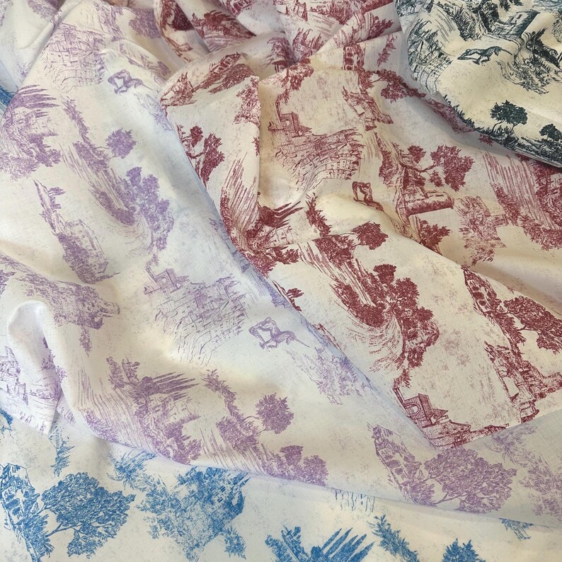May include: Three pieces of fabric with a white background and a repeating pattern of a countryside scene in shades of blue, pink, and red.