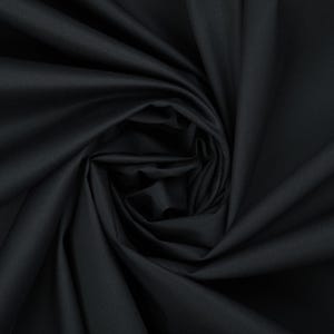 May include: Black fabric with a smooth, silky texture. The fabric is folded and draped, creating a soft, flowing look.