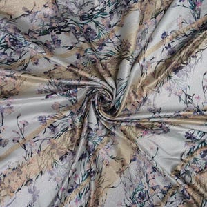 May include: Silver fabric with a gold and pink floral print. The fabric has a subtle shimmer and a soft texture.