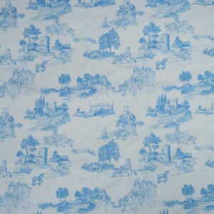May include: A blue and white patterned fabric with a repeating design of a small castle, trees, and a unicorn. The background is a light blue color.