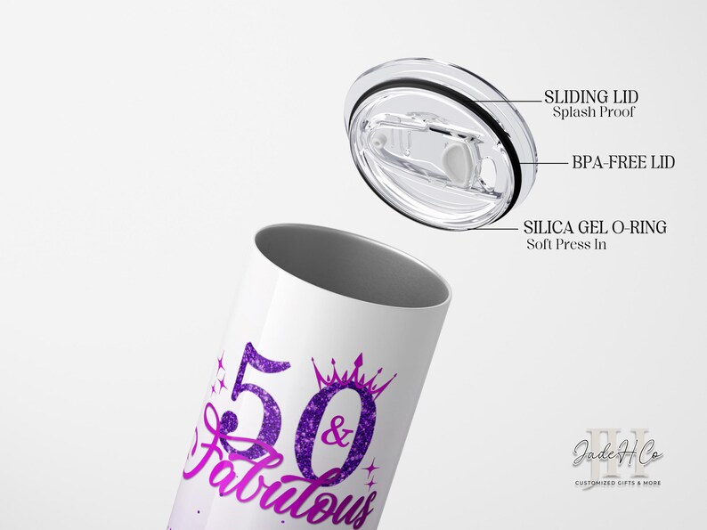 May include: A white stainless steel tumbler with a purple and pink glitter design that says "50 & Fabulous". The tumbler has a clear, sliding lid with a silicone O-ring.